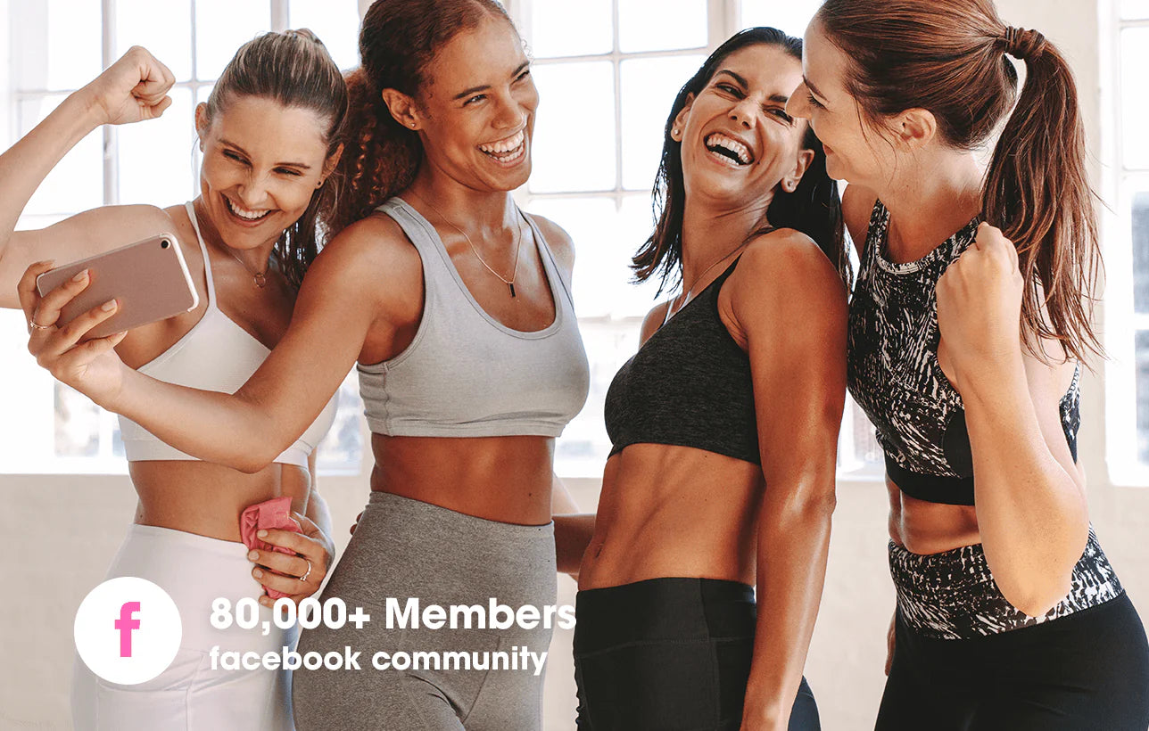 Four women in athletic wear taking a selfie together